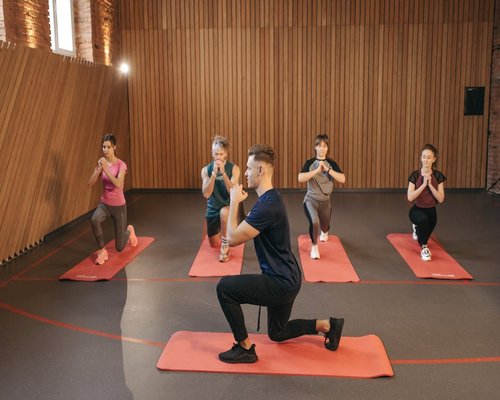 Group of people doing functional training in a dark lit studio