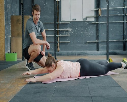 Stretching and mobility routine on gym floor