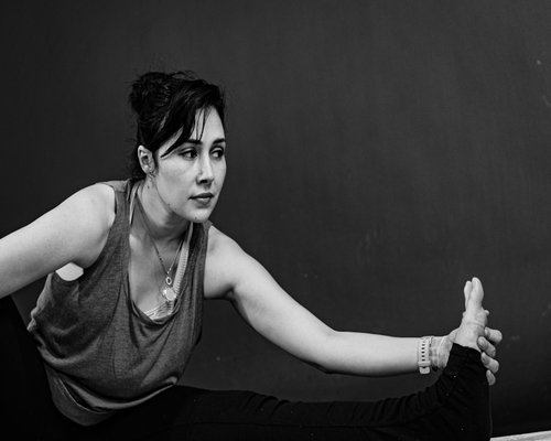 Portrait of instructor Sofía showing a stretch